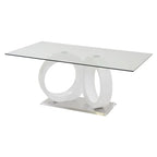 Tavolo da pranzo con piano in vetro, basamento a colonna in MDF bianco, base cromata
